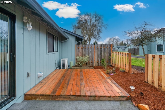 wooden terrace featuring ac unit and fence