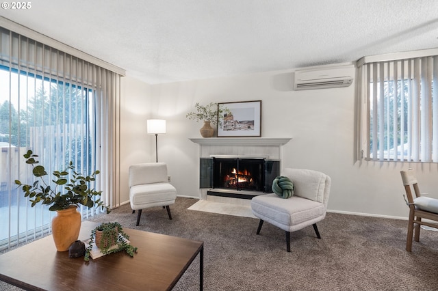 carpeted living area with a wall mounted air conditioner, a healthy amount of sunlight, a fireplace, and a textured ceiling