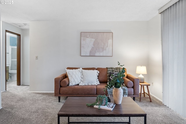 living area with light carpet and baseboards