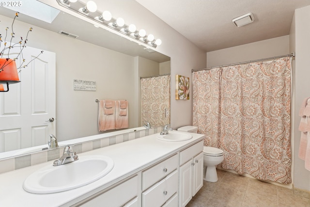 full bath featuring toilet, visible vents, a sink, and tile patterned flooring