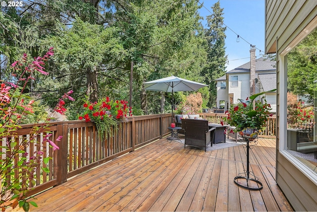wooden terrace with outdoor dining space