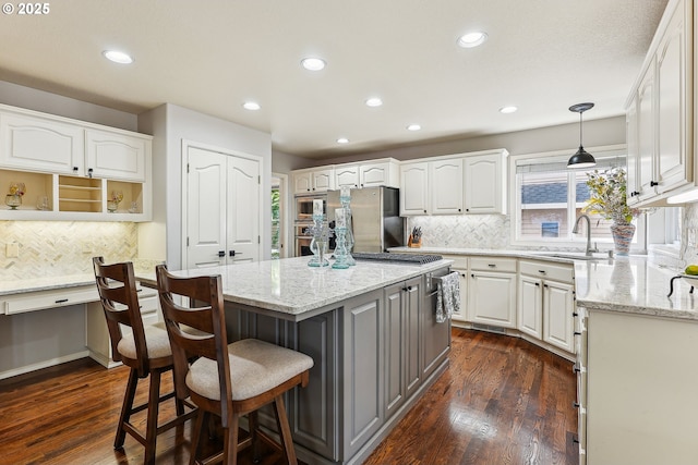 kitchen with recessed lighting, white cabinetry, a sink, and tasteful backsplash