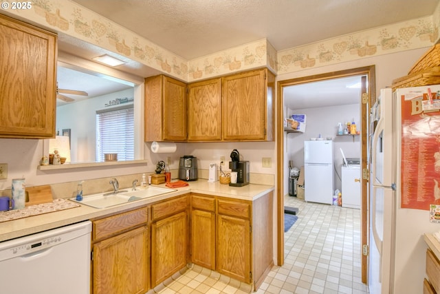 1318 SW 39th Ave, Pendleton, OR 97801 - kitchen featuring white appliances, a sink, washer / clothes dryer, light countertops, and brown cabinets