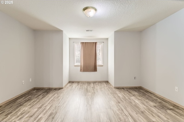 1165 SE 85th Ave, Portland, OR 97216 - unfurnished room featuring light wood finished floors and a textured ceiling