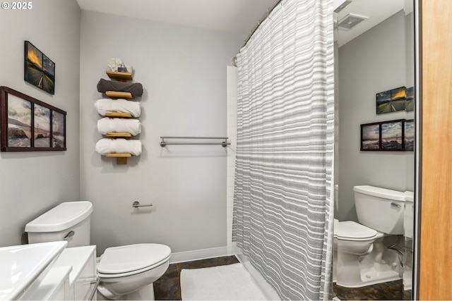 1420 NW Lovejoy St Unit 518, Portland, OR 97209 - bathroom featuring toilet, vanity, curtained shower, and baseboards
