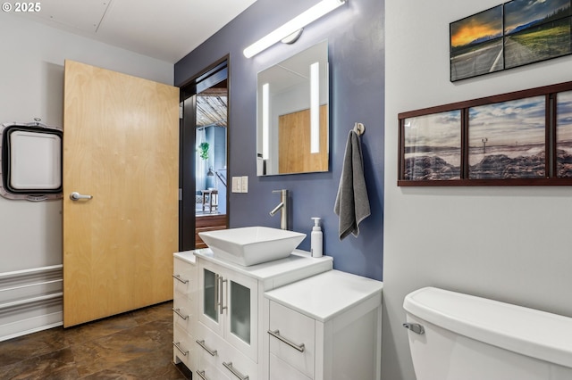 1420 NW Lovejoy St Unit 518, Portland, OR 97209 - bathroom featuring toilet, vanity, and stone finish floors
