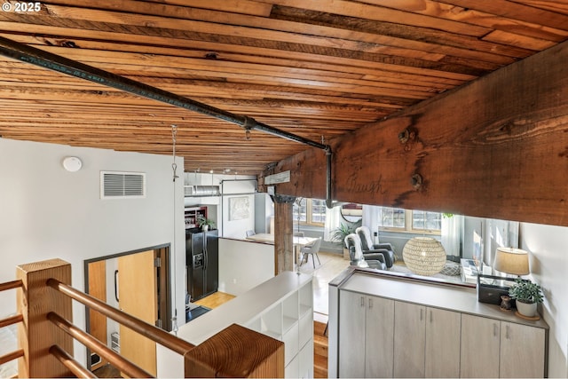 basement featuring wood ceiling and light hardwood / wood-style floors