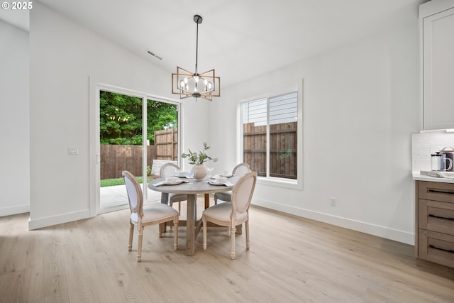 5404 NE 111th St, Vancouver, WA 98686 - dining space featuring light wood finished floors, a chandelier, healthy amount of natural light, and vaulted ceiling
