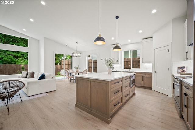 5404 NE 111th St, Vancouver, WA 98686 - kitchen featuring stainless steel electric stove, light wood finished floors, recessed lighting, a center island, and pendant lighting
