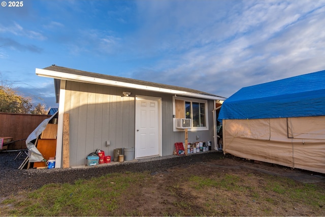 view of outdoor structure featuring fence and cooling unit