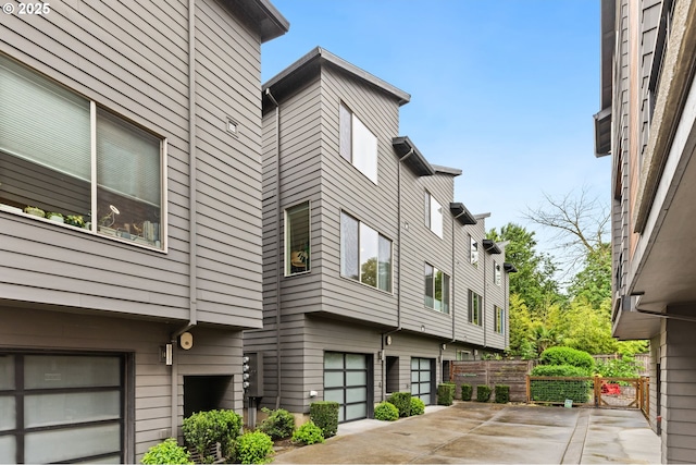 5026 SE Mill St, Portland, OR 97215 - view of building exterior with a garage and driveway