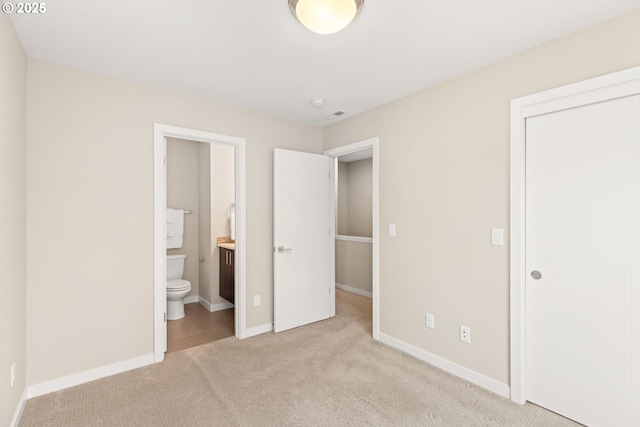 5026 SE Mill St, Portland, OR 97215 - unfurnished bedroom featuring carpet flooring, a closet, baseboards, and ensuite bathroom