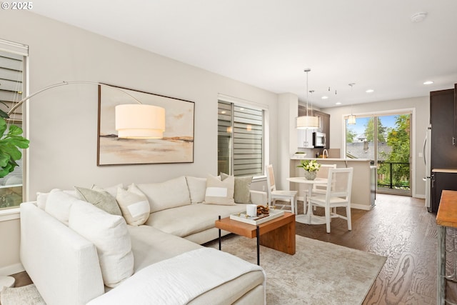 5026 SE Mill St, Portland, OR 97215 - living area featuring recessed lighting, wood finished floors, and baseboards