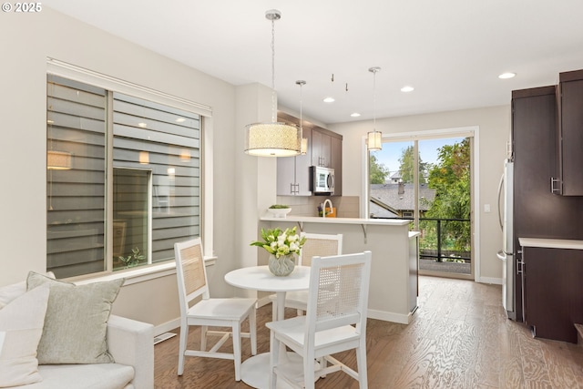 5026 SE Mill St, Portland, OR 97215 - dining space with light wood-style flooring, recessed lighting, and baseboards
