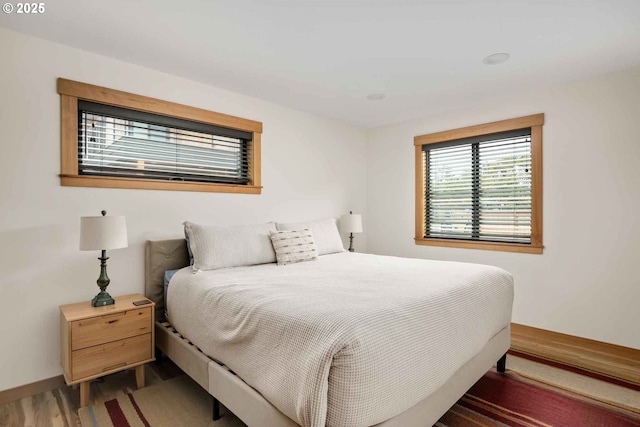 bedroom featuring wood finished floors and baseboards