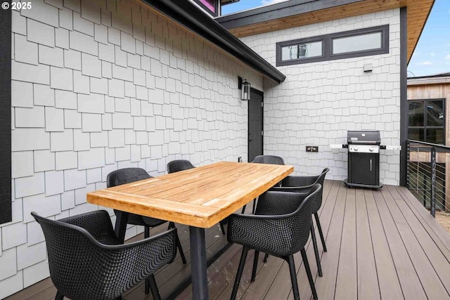 deck featuring area for grilling and outdoor dining space
