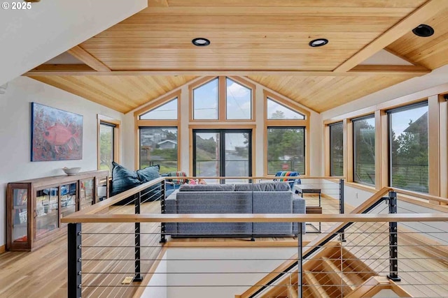 living area featuring wooden ceiling and healthy amount of natural light