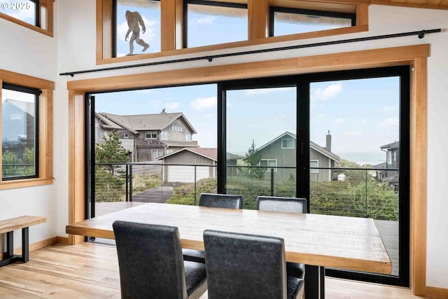 dining area with baseboards, wood finished floors, and a residential view