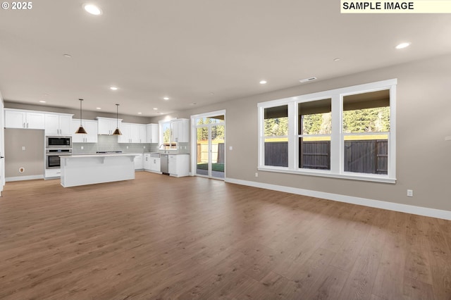 17301 SW Atfalati Ln Unit 38, Sherwood, OR 97140 - unfurnished living room featuring recessed lighting and light wood-style flooring