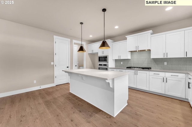 17301 SW Atfalati Ln Unit 38, Sherwood, OR 97140 - kitchen featuring appliances with stainless steel finishes, white cabinets, light countertops, light wood-type flooring, and recessed lighting