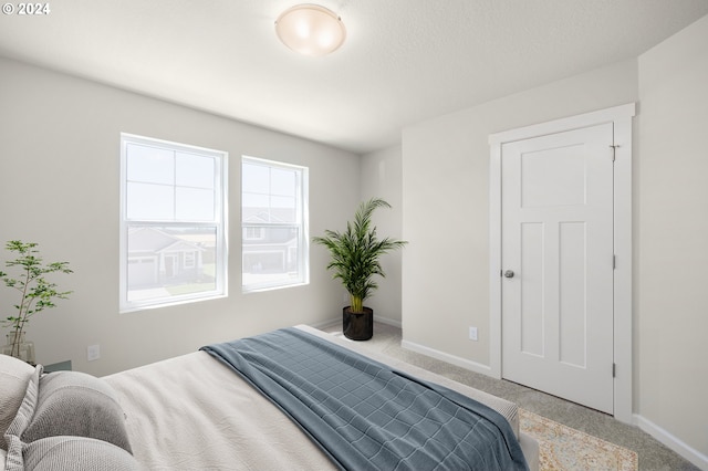 bedroom with carpet flooring and baseboards