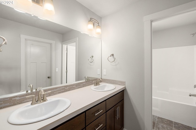 full bathroom featuring double vanity and a sink