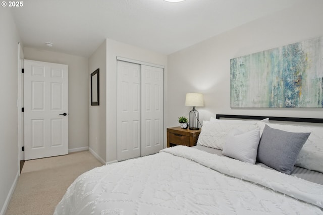 carpeted bedroom featuring a closet and baseboards