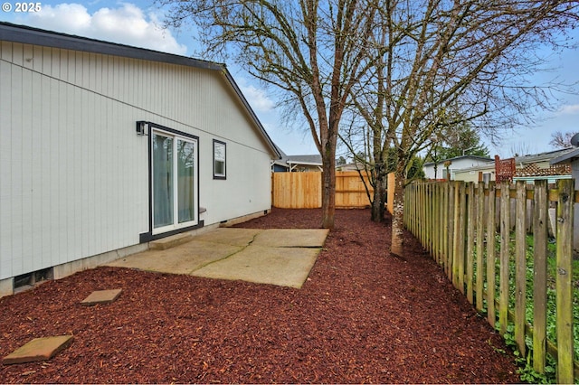 view of yard featuring a patio area and a fenced backyard