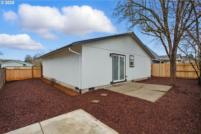 rear view of house with a patio area and a fenced backyard