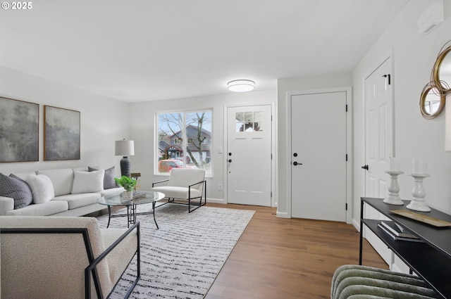 living area featuring baseboards and wood finished floors