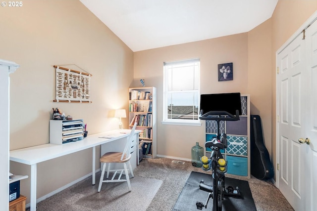 carpeted office featuring baseboards and vaulted ceiling