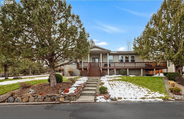 view of front of house featuring a front lawn, stairway, and an attached garage