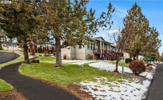 view of property exterior with stairway and a lawn