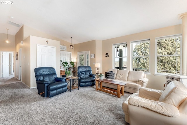 carpeted living room with vaulted ceiling