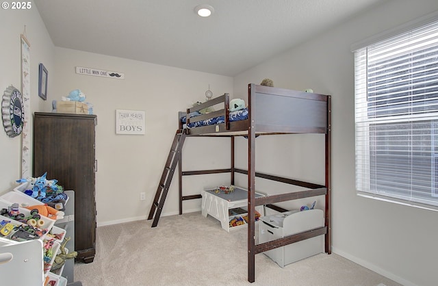 bedroom featuring light carpet