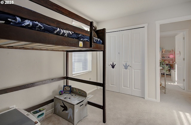 bedroom with light carpet and a closet