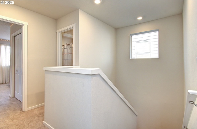 hallway featuring light carpet