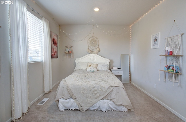 carpeted bedroom with multiple windows