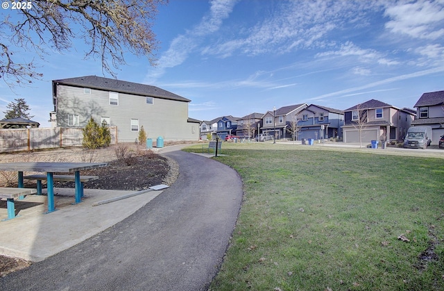 view of home's community with a yard