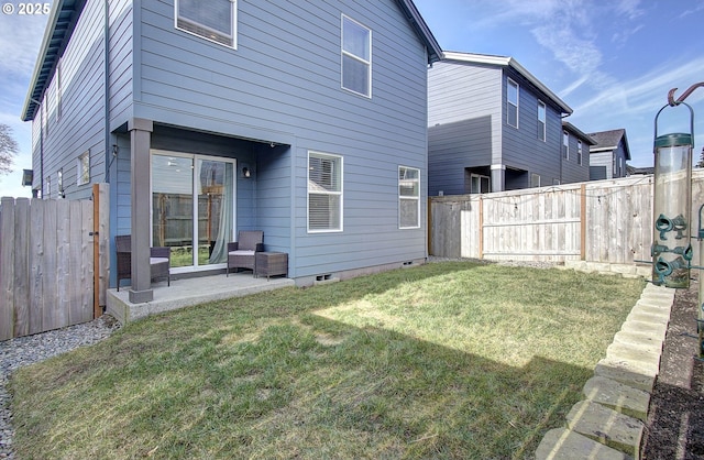 rear view of property with a yard and a patio area