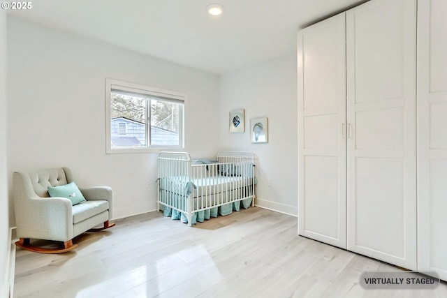 4235 SE Jackson St, Milwaukie, OR 97222 - bedroom with a crib, light wood-style flooring, baseboards, and recessed lighting