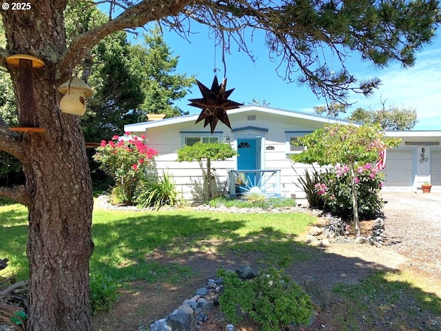 view of front of house with a garage and a front yard