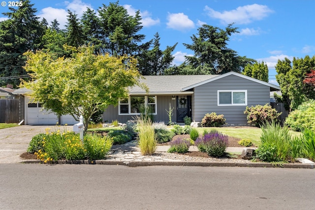 9885 SW Bonnie Brae Dr, Beaverton, OR 97008 - view of front of home with concrete driveway, board and batten siding, and a shingled roof