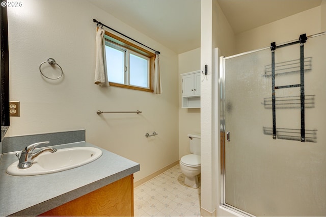 bathroom featuring vanity, toilet, tile patterned floors, baseboards, and a shower stall
