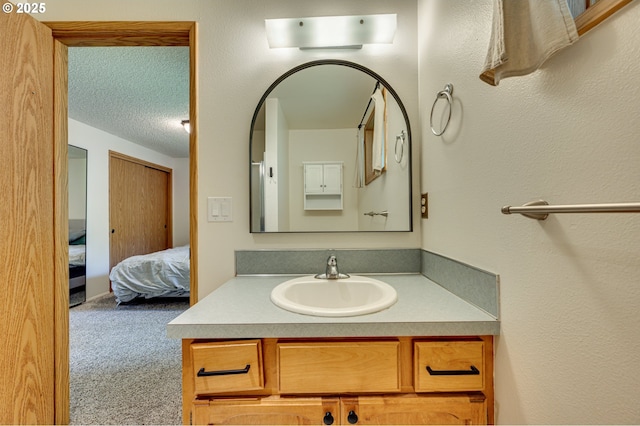 bathroom with vanity and ensuite bath