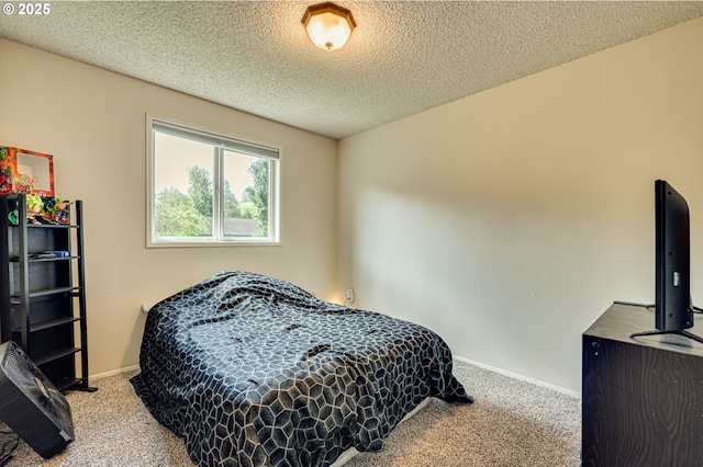 bedroom featuring baseboards, carpet, and a textured ceiling