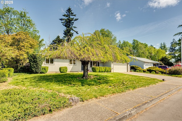 view of front of home featuring a garage, a front lawn, and driveway
