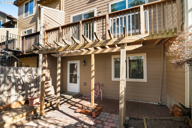 back of property featuring fence, a pergola, and a patio