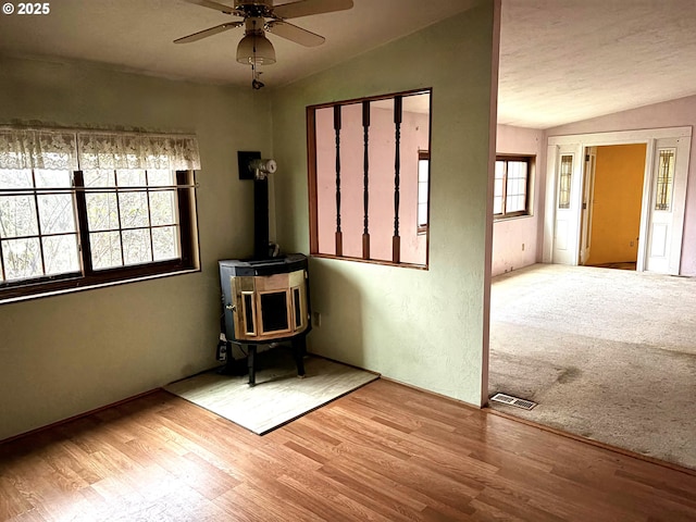 14755 S Graves Rd, Mulino, OR 97042 - spare room featuring wood finished floors, lofted ceiling, ceiling fan, and a wood stove