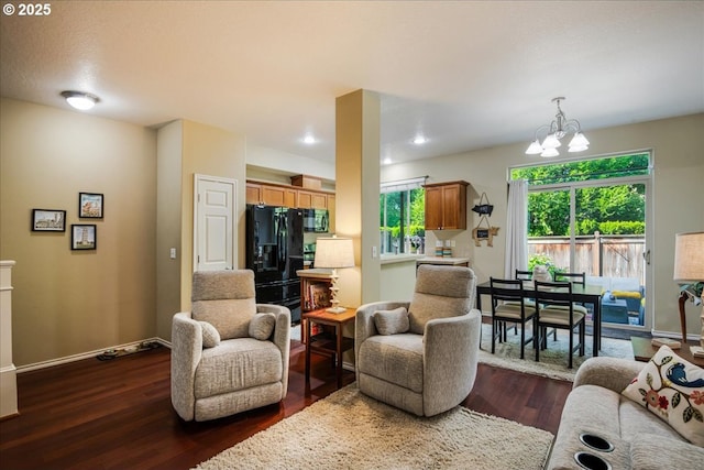 16181 SW Holland Ln, Sherwood, OR 97140 - living room featuring dark wood-type flooring, a chandelier, and baseboards